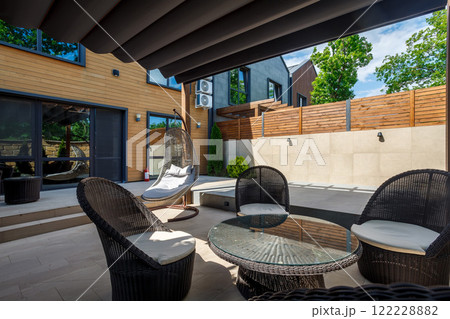 Backyard outdoor bbq zone with pergola, fireplace and hanging chair. Summer party place Backyard outdoor bbq zone with pergola, fireplace and hanging chair. Summer party place 122228882