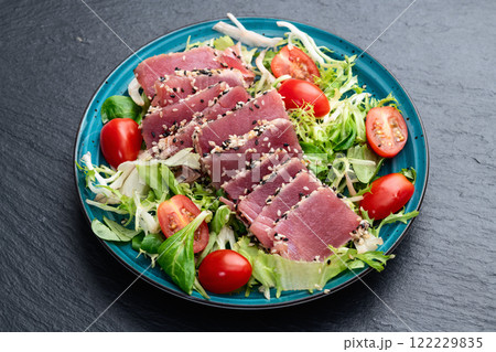 Salad with raw tuna , sesame and cherry tomatoes photography . Top view Salad with raw tuna , sesame and cherry tomatoes photography . Top view 122229835