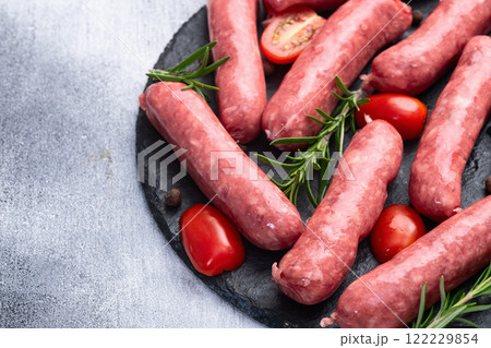 Raw beef sausages with rosemary and tomatoes photography . Top view Raw beef sausages with rosemary and tomatoes photography . Top view 122229854