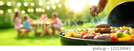 A vibrant outdoor barbecue scene with burgers and vegetables grilling on the barbecue, while family and friends 122230043