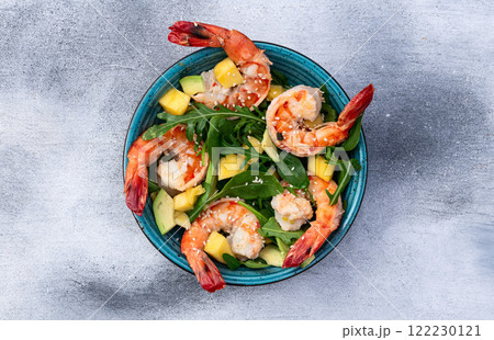 Salad with tiger shrimps , avocado and mango . Top view Salad with tiger shrimps , avocado and mango . Top view 122230121
