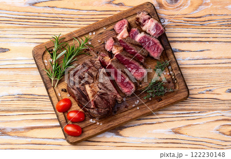 Ribeye grilled beef steak sliced . Rare doneness photography . Top view Ribeye grilled beef steak sliced . Rare doneness photography . Top view 122230148