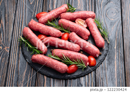 Raw beef sausages with rosemary and tomatoes photography . Top view Raw beef sausages with rosemary and tomatoes photography . Top view 122230424
