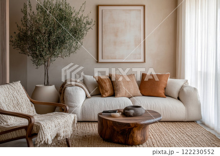 Minimalist elegant living room design with sofa and armchair, use of natural materials and abstract paintings for interior decoration and creation of coziness 122230552