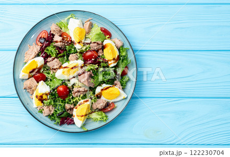 Canned Tuna salad with eggs and tomatoes photography . Top view 122230704