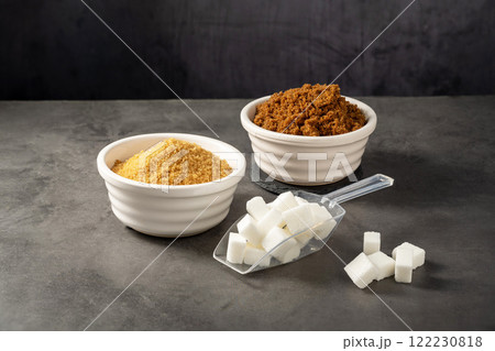 Different type of sugar. Light brown, dark brown and white sugar cubes in bowls. Different type of sugar. Light brown, dark brown and white sugar cubes in bowls. 122230818