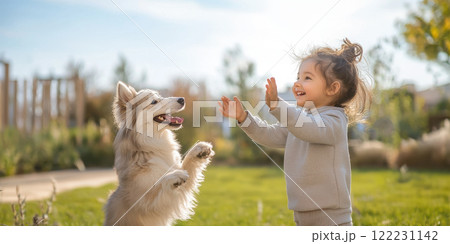 child and their pet dog enjoying playful moment outdoors together 122231142