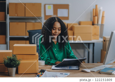Portrait of Starting small businesses SME owners female entrepreneurs working on receipt box and check online orders to prepare to pack the boxes, sell to customers, SME business ideas online. 122231809