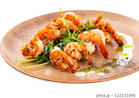 Plate of grilled shrimps served with sauce isolated at white background. 122231993
