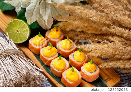 Set of hot philadelphia sushi rolls at decorated restaurant table background. 122232038