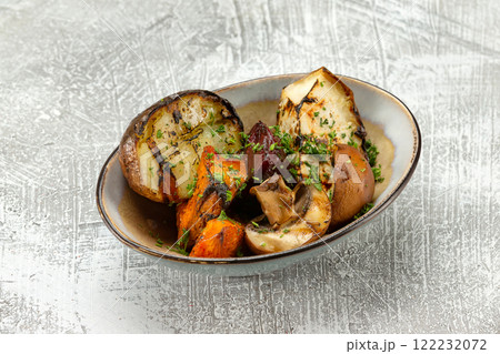 Closeup plate of grilled vegetables - potato, mushrooms, pumpkin and squash at concrete table background. Closeup plate of grilled vegetables - potato, mushrooms, pumpkin and squash at concrete table background. 122232072