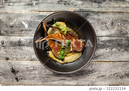 Pan of grilled lamb served with mashed potatoes at wooden rustic table background. Pan of grilled lamb served with mashed potatoes at wooden rustic table background. 122232134