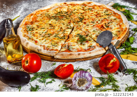 Tasty italian vegeterian pizza with fresh golden cheese and tomato at wooden background. 122232143