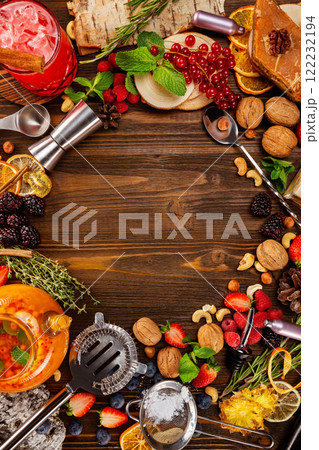 Top view image image of tea ceremony with natural food ingredients around - berries,. nuts and kitchenware at wooden table background. 122232194