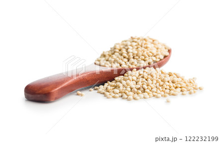 White uncooked quinoa seeds on spoon isolated on white background. 122232199