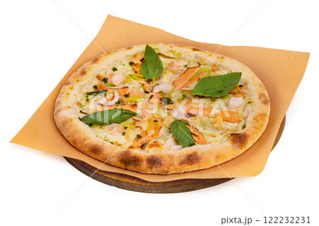 Tasty italian pizza with salmon, seafood and basil on a paper at wooden board isolated at white background. 122232231