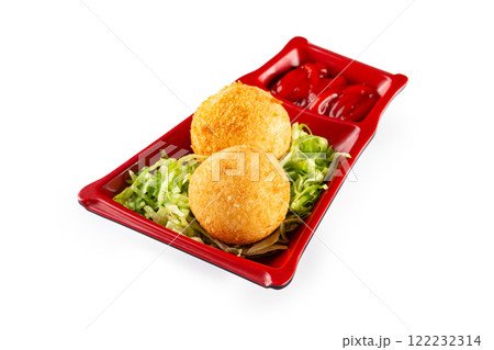 Plate of crispy golden round meat nuggets balls served with greens and ketchup isolated at white background. 122232314