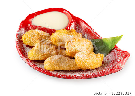 Plate of tasty sweet battered fruit nuggets served with condensed milk and sugar powder isolated at white background. 122232317