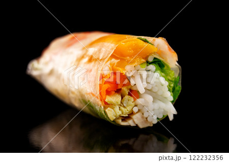 Closeup image of goi cuon spring rolls with shrimps, onion, mango, pork and noodles isolated at black background. Traditional vietnamese food. Closeup image of goi cuon spring rolls with shrimps, onion, mango, pork and noodles isolated at black background. Traditional vietnamese food. 122232356