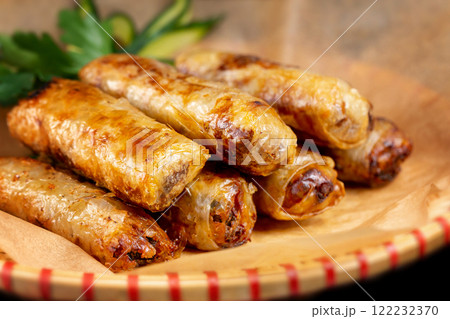 Closeup asian fried spring rolls on a plate with paper. Closeup asian fried spring rolls on a plate with paper. 122232370
