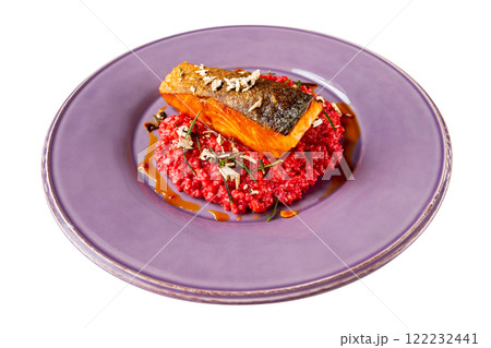 Plate of salmon steak served with pink bulgur risotto isolated at white background. 122232441