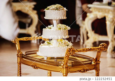 Image of tasty traditional wedding white cake with flowers figures. Image of tasty traditional wedding white cake with flowers figures. 122232451