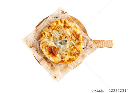 Yellow crispy adzharian khachapuri on a cooking paper on a wooden tray isolated at white background. 122232514