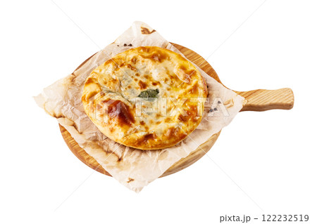 Yellow crispy adzharian khachapuri on a cooking paper on a wooden tray isolated at white background. 122232519