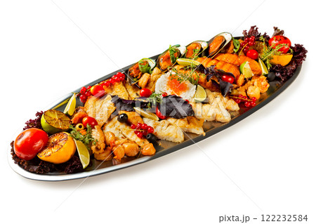 Top view metal dish set of seafood, fish and vegetables isolated at white background. Top view metal dish set of seafood, fish and vegetables isolated at white background. 122232584