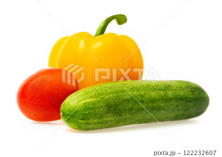 Closeup image of vegetables festive three colors group. Red tomato, green cucumber and yellow pepper isolated at white background. 122232607