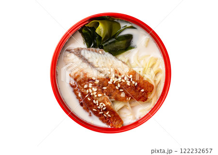 Closup top view image of bowl with thai unagi soup isolated at white background. 122232657