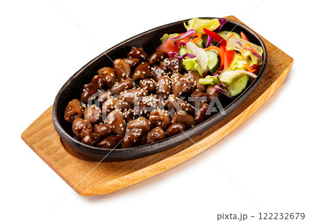 Pan of traditional Japanese yakitori dish - fried checken hearts served with sesame, teriyaki sauce and fresh vegetables at wooden board isolated at white background. Pan of traditional Japanese yakitori dish - fried checken hearts served with sesame, teriyaki sauce and fresh vegetables at wooden board isolated at white background. 122232679