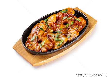 Pan of fried chicken fillet with pineapple rings and onion served with teiyaki sauce at wooden board isolated at white background. Pan of fried chicken fillet with pineapple rings and onion served with teiyaki sauce at wooden board isolated at white background. 122232708