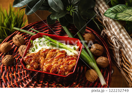 Spicy pork chop with omelete served with rice at decorated wooden table background. Spicy pork chop with omelete served with rice at decorated wooden table background. 122232749