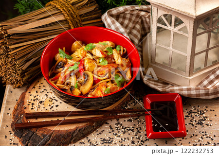 Bow of traditional asian egg noodles with chicken, vegetables and mushrooms at decorated wooden table background. 122232753