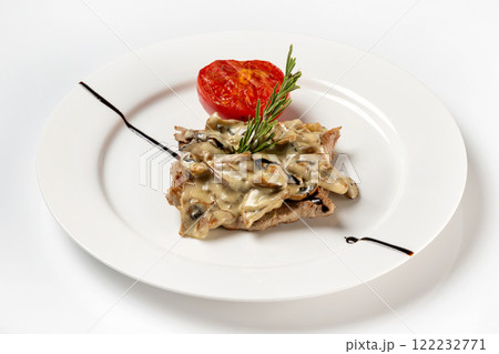 Plate of beef steak served with white mushrooms sauce and tomato isolated at white background. 122232771