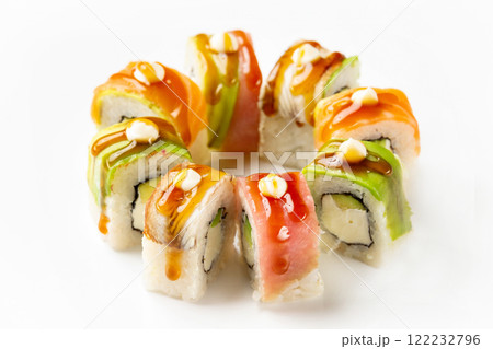 Colorful rainbow maki sushi rolls with salmon, avocado, cream cheese and eel decorated with teriyaki sauce isolated at white background. 122232796