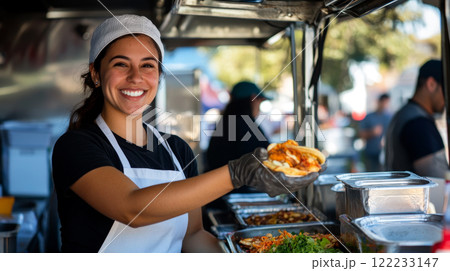 Friendly food vendor offering a meal at an outdoor stand 122233147