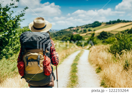 Lonely Pilgrim with backpack walking the Camino de Santiago, Way of St James 122233264