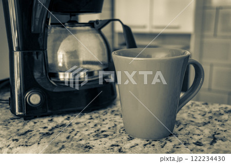 Coffee machine and red cup on table in the kitchen. Coffee machine and red cup on table in the kitchen. 122234430