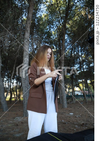 Girl Walks With Guitar Bass Instrument Case Behind Her In The Park Girl Walks With Guitar Bass Instrument Case Behind Her In The Park 122234750