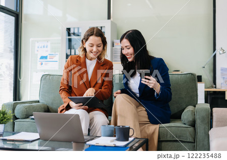 Diverse Business Team Discusses Financial Project Analysis in Meeting. 122235488