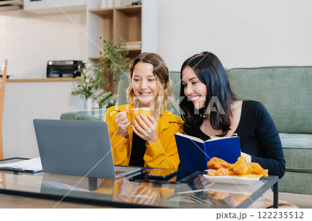 Lifestyle Women Reading, Working on Laptop, and Enjoying Coffee. Lifestyle Women Reading, Working on Laptop, and Enjoying Coffee. 122235512
