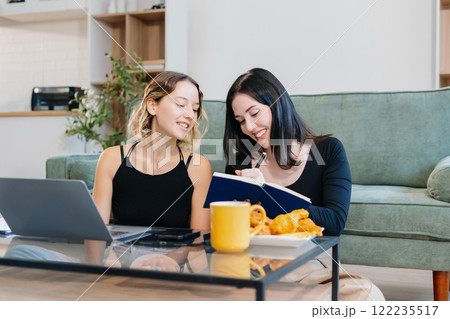 Lifestyle Women Reading, Working on Laptop, and Enjoying Coffee. 122235517