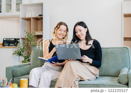 Office Lifestyle: Two Woman Reviews Business Project at Home Office. 122235527