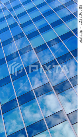 Cloud ReflectionsA stunning interplay of curved architectural lines and mirrored glass, capturing the soft patterns of drifting clouds. The juxtaposition of the building's structure against the 122236388