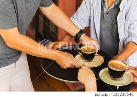 Senior man serving coffee with help of customer at cafe. Senior man serving coffee with help of customer at cafe. 122236540