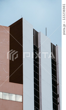 Urban Layers. A vertical juxtaposition of architectural surfaces and muted colors, presenting a harmonious play of light, texture, and modern design 122236981