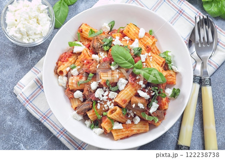 Rigatoni alla Norma pasta with eggplant, tomato, basil and ricotta salata, horizontal top view 122238738