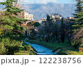 The Lana River with houses and mountains in the background, Tirana, Albania 122238756